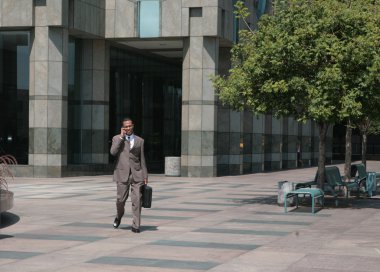 Businessman Walking Through Courtyard clipart