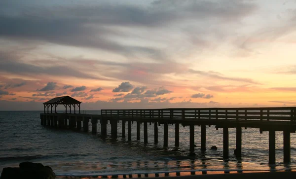 Stock image Hawaiian Pier at Sunset With Colorful Cl