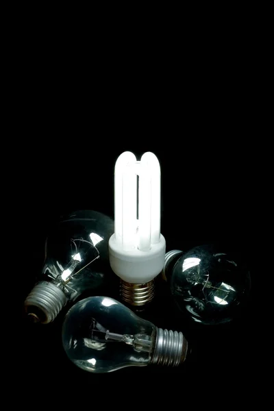 stock image Power saving lamp shines over bulbs