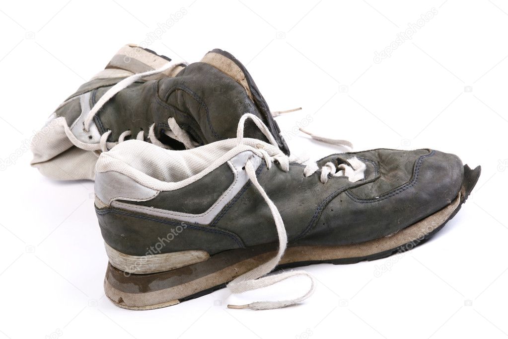 Old grungy Running Shoes isolated on whi