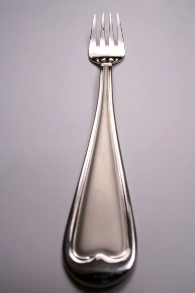 Tenedor de plata sobre fondo gris — Foto de Stock
