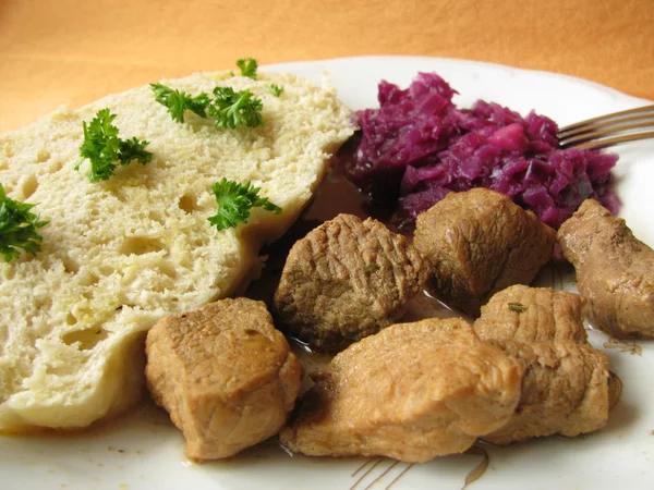 Dumpling with goulash and red cabbage — Stock Photo, Image