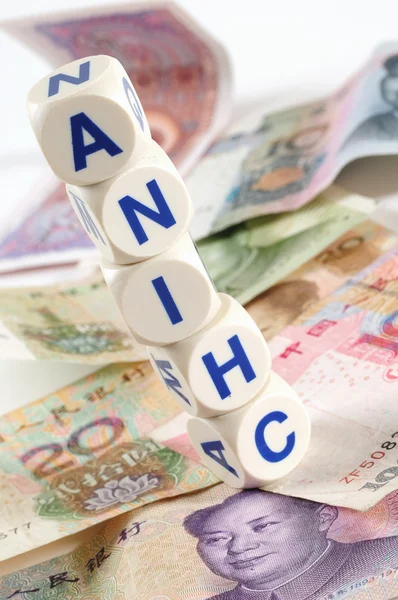 stock image Dice on chinese currencies