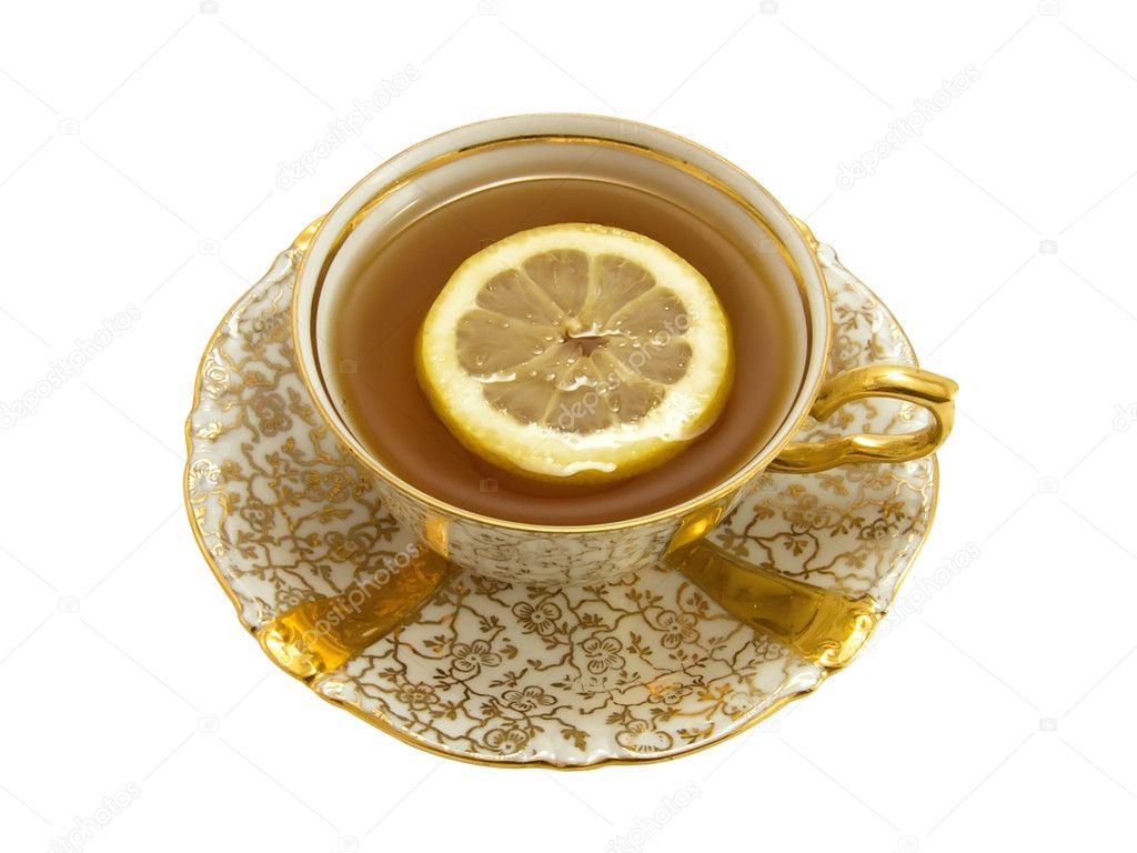 Gold porcelain cup with tea and lemon