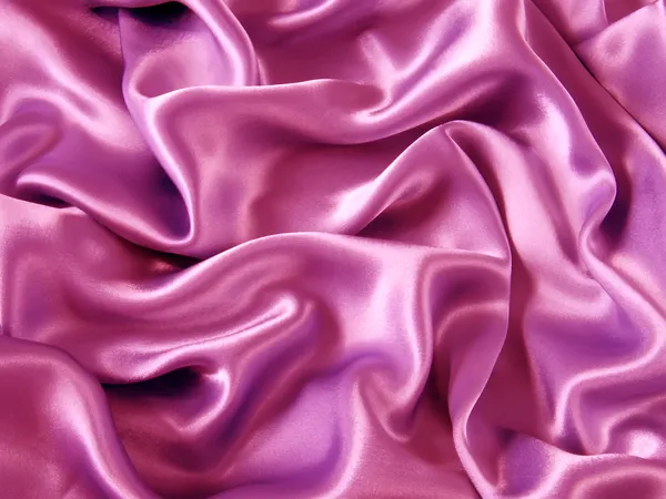 Розовая атласная шелковая ткань в качестве фона — стоковое фото