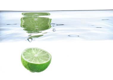 Lime just after falling under the water clipart