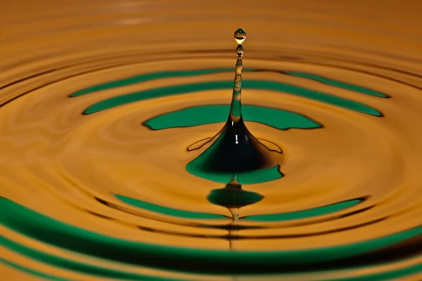 Drop bouncing off a water surface — Stock Photo, Image