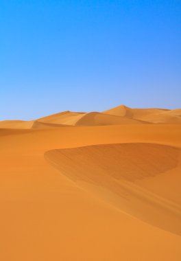 Sand dunes and cloudless sky clipart