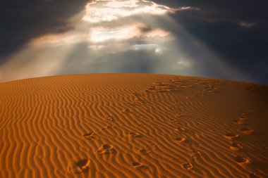 Sky split over the desert sand clipart