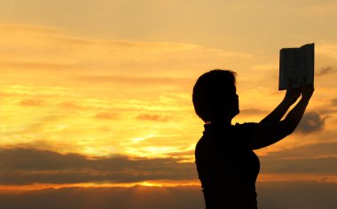 Female praying with bible clipart