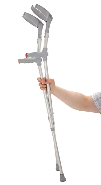 Hand holding crutches — Stock Photo, Image