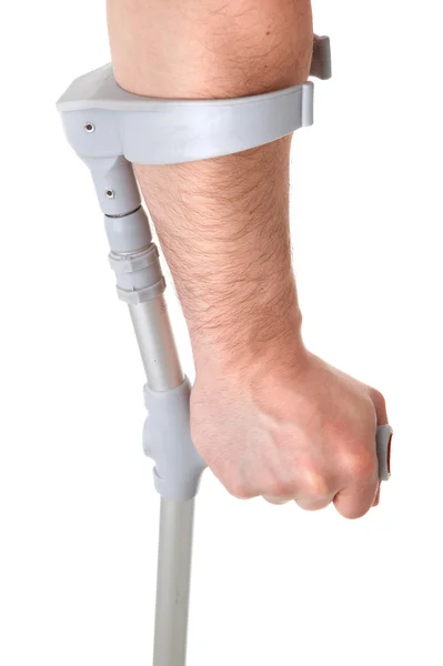 Mão segurando muleta — Fotografia de Stock