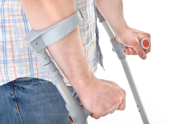 Man walking with a crutch — Stock Photo, Image