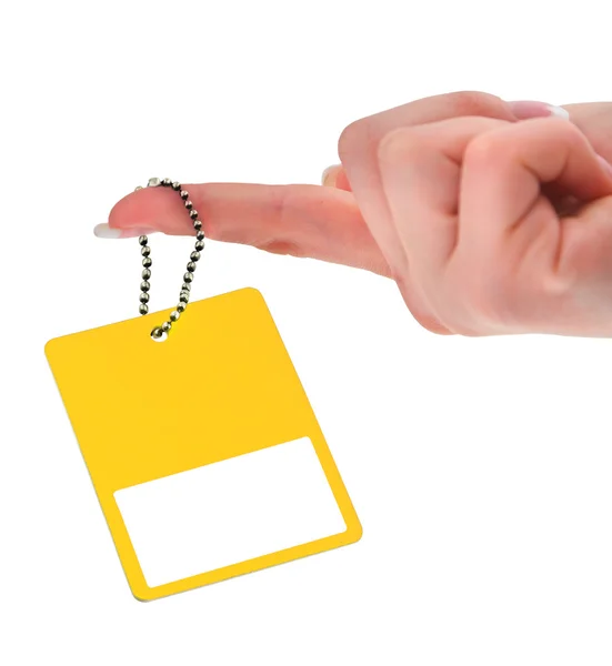 Hand holding yellow price tag — Stock Photo, Image