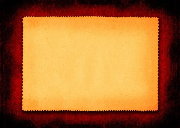Stück vergilbtes Papier auf Rot — Stockfoto