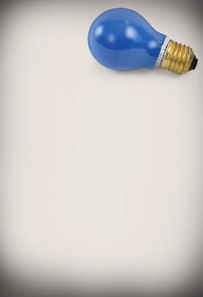 Light bulb against abstract background — Stock Photo, Image