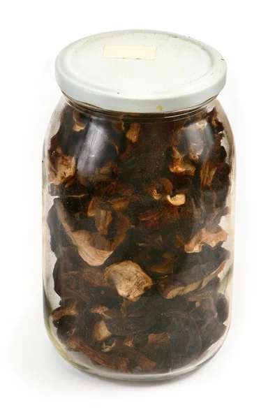 Frasco de vidro cheio de cogumelos secos — Fotografia de Stock