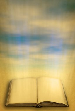 Open holy book against heaven clipart