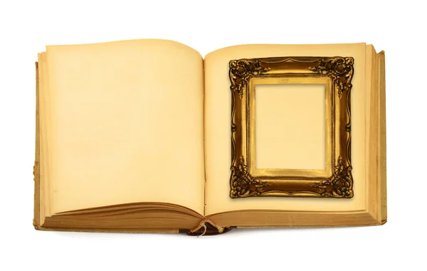 Decorative frame lying on an open book — Stock Photo, Image