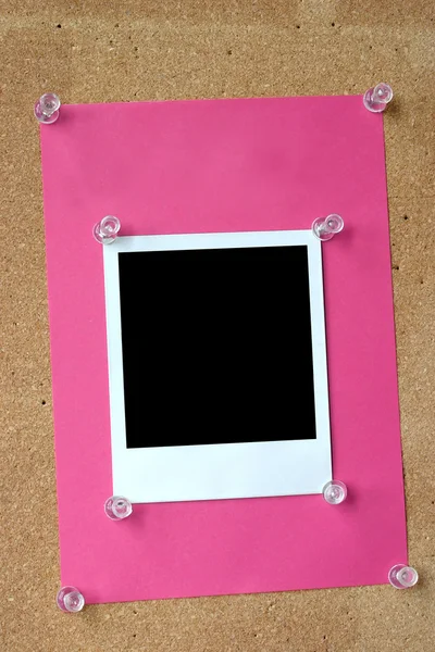 Photo frame thumbtacked to cork board — Stock Photo, Image