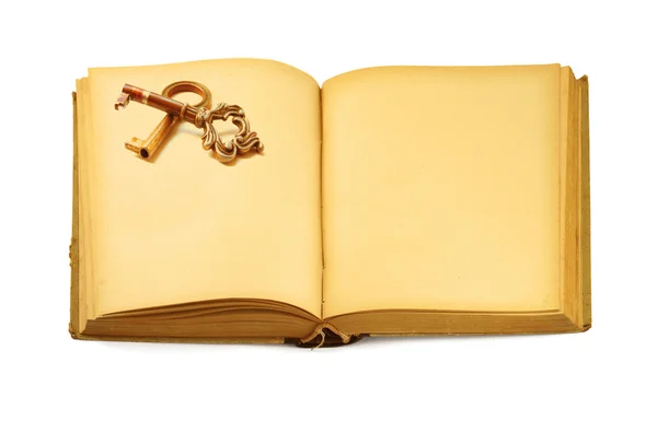 Abrir livro antigo com motivo chave — Fotografia de Stock