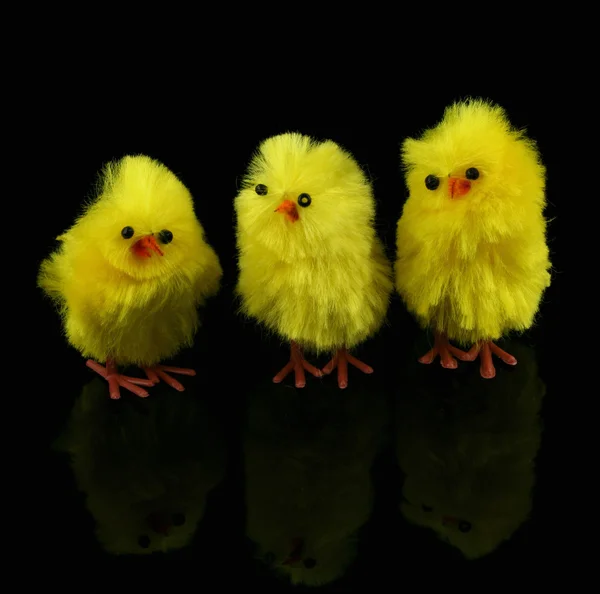 Toy Easter chickens on black — Stock Photo, Image