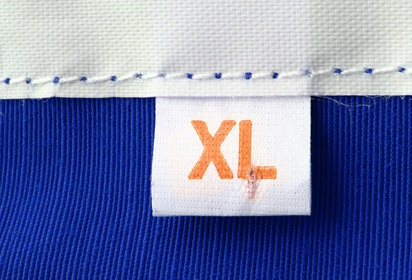 Macro real de tamaño XL etiqueta de ropa — Foto de Stock