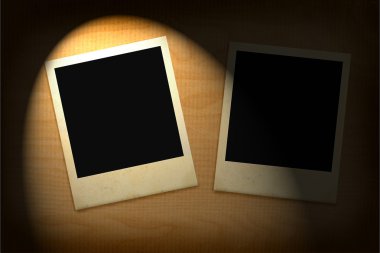 Two old photo frames lit in darkness clipart