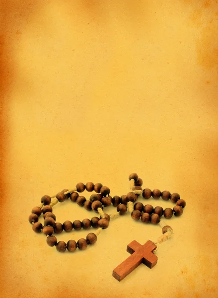 Wooden rosary against retro background — Stock Photo, Image