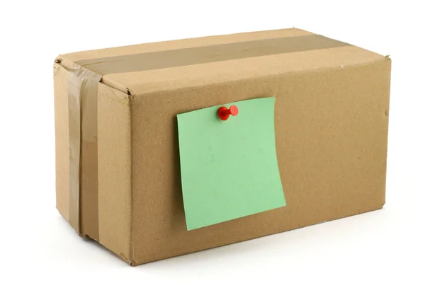 Cardboard box with pinned note — Stock Photo, Image