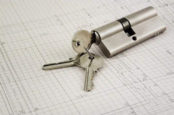 Door lock with keys on a building plans — Stock Photo, Image