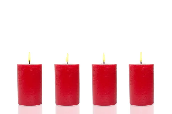 Čtyři červené svíčky, čtyři vypalování — Stock fotografie
