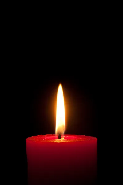 Red candle in front of black background — Stock Photo, Image