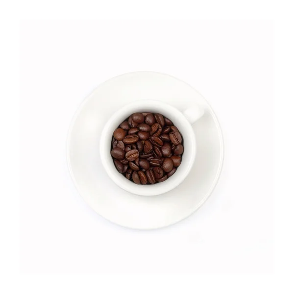 White coffee cup, full with coffee beans Royalty Free Stock Photos