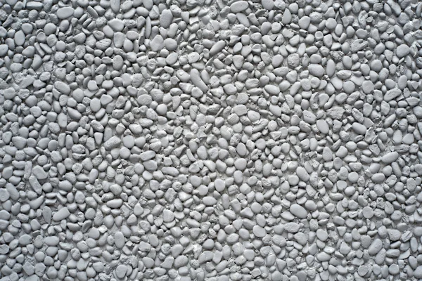 Pedras de seixo pintadas de cinza em uma parede — Fotografia de Stock