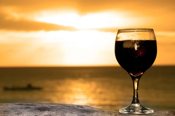 stock image Glass of wine on the beach