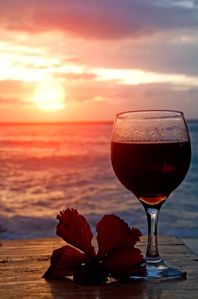 stock image Glass of wine on the beach