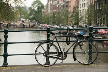 Bike parked on a bridge clipart