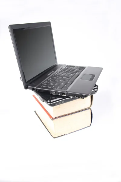 Notebook computers on thick of books — Stock Photo, Image
