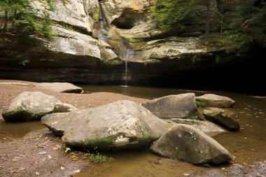 Trickling Waterfall by Boulders clipart