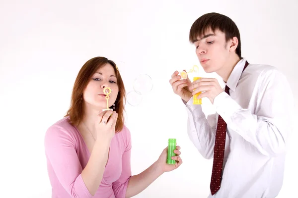 Romantic couple blowing soap bubbles — Stock Photo, Image