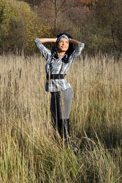 Vacker ung kvinna stående på fältet — Stockfoto