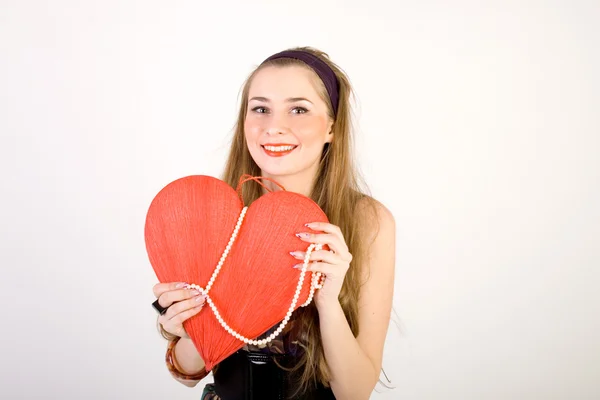 Beautiful woman holding red heart — Stock Photo, Image