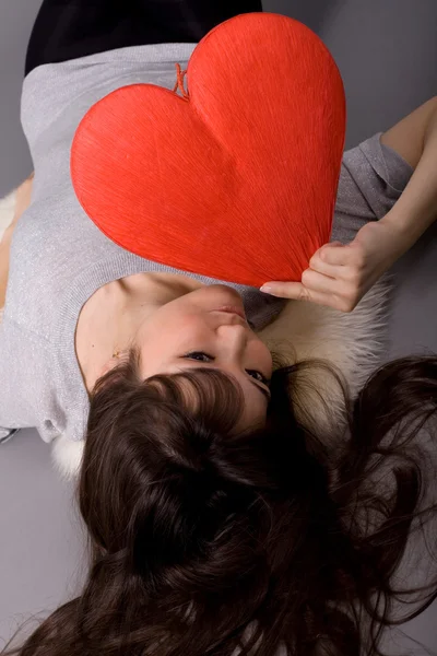 Beautiful woman holding red heart — Stock Photo, Image