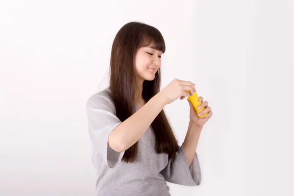 Girl blowing soap bubbles in studio — Stock Photo, Image