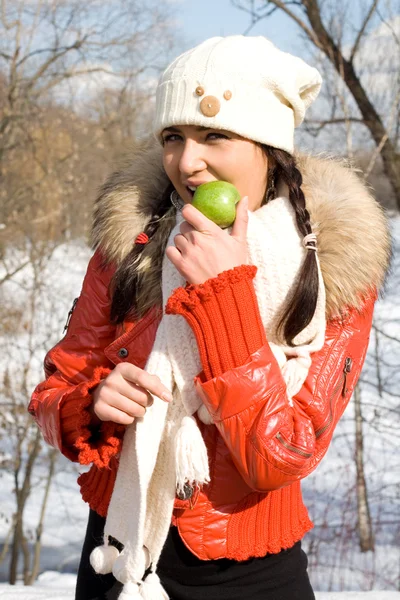 Funny girl eating apple outdoor — Stock Photo, Image