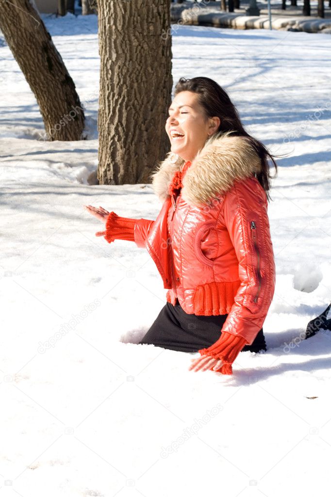Happy girl fell in a snowdrift