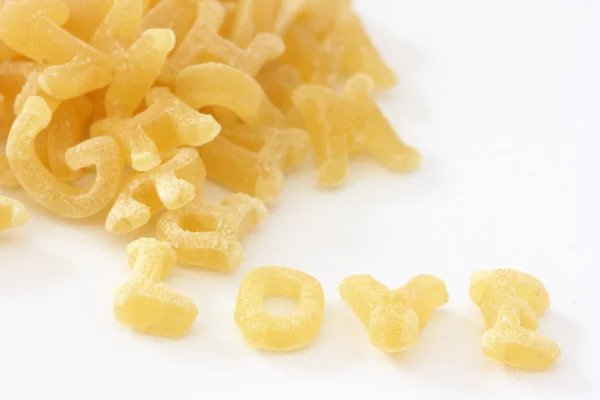 Pasta noodles forming word love — Stock Photo, Image