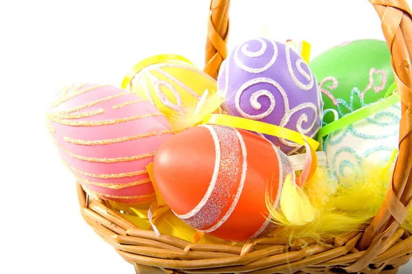 Cane basket with colorful easter eggs — Stock Photo, Image