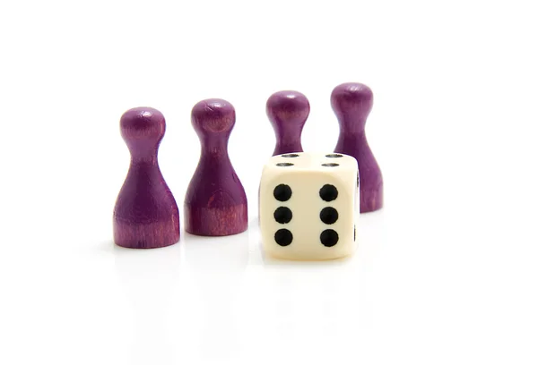 Four purple wooden pawns with dice — Stock Photo, Image